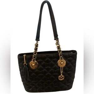 Metrocity black quilted leather shoulder bag with gold-tone hardware.